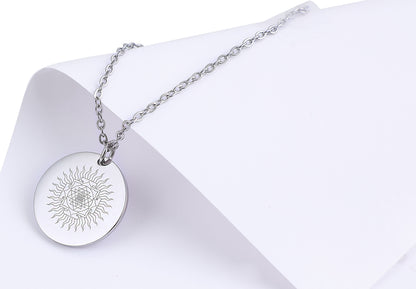 Silver necklace with a round pendant on a white background